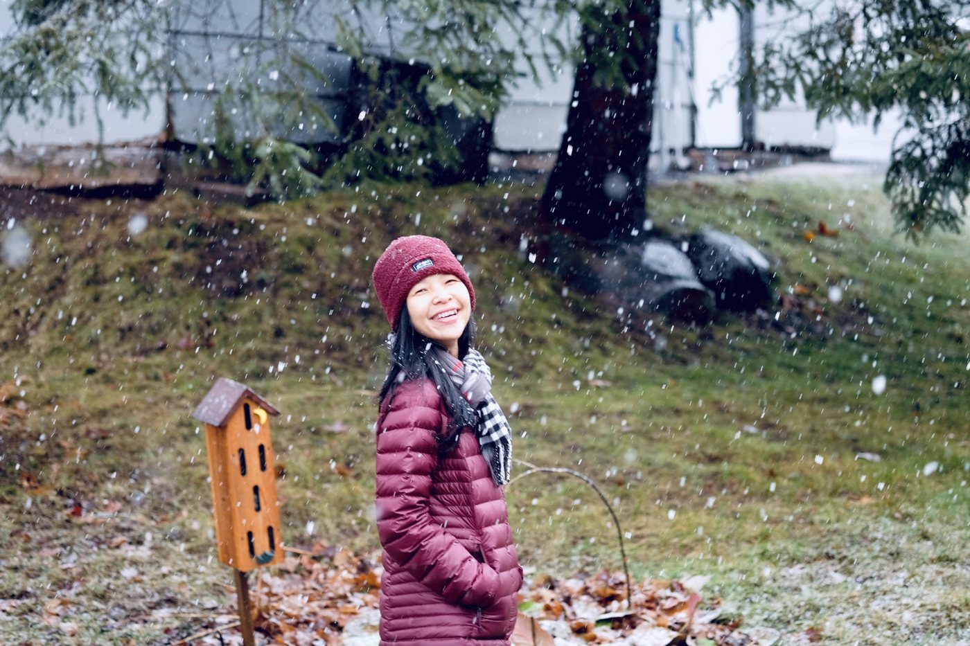 Cristal smiling outdoors as snow falls